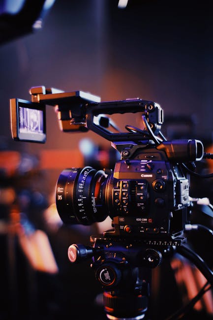 Close-up of a professional video camera setup indoors, capturing high-quality footage.